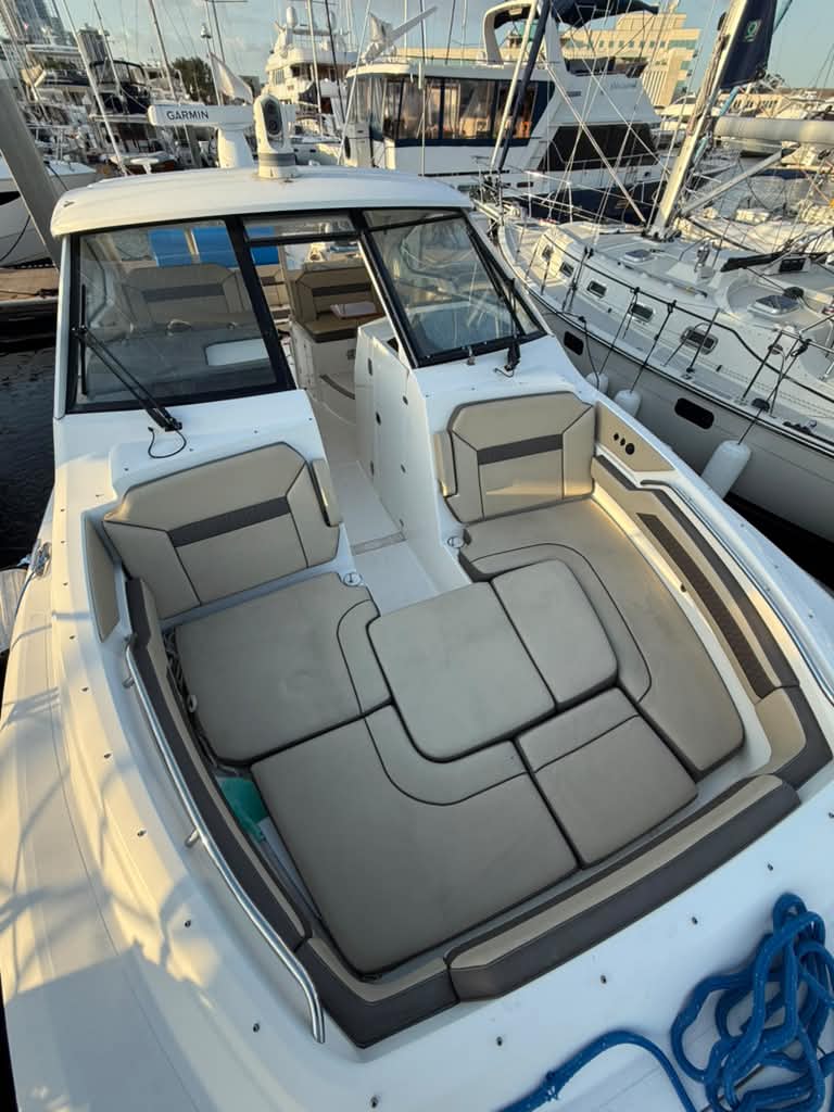 The freshly detailed bow seating and helm of a cabin cruiser docked in a Tampa Bay marina