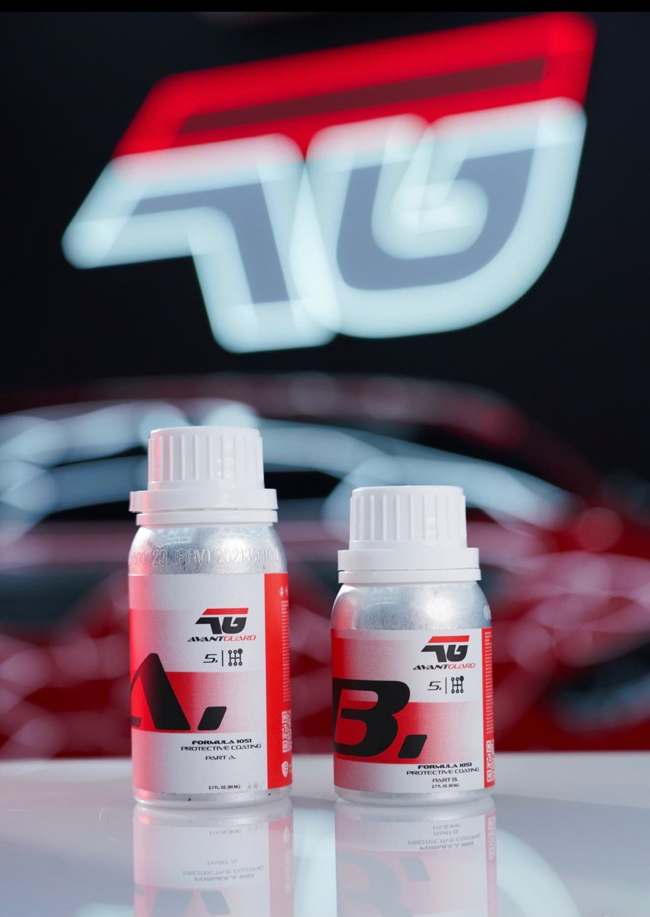 The two-part AvantGuard Formula 1051 coating kit, Part A and Part B, on a mirrored bench