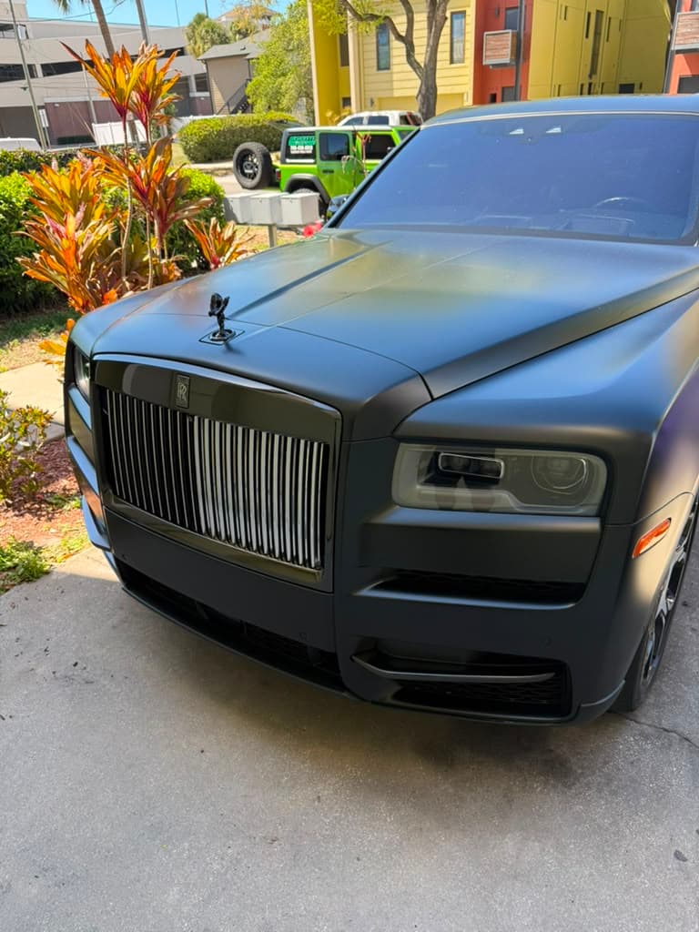 Matte black luxury SUV detailed on the driveway at the client's home